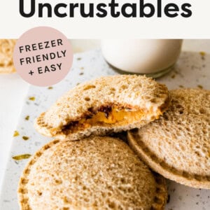Three homemade uncrustable sandwiches. One has a bite taken out of it so you can see the peanut butter and jelly inside.
