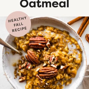 Bowl of pumpkin oatmeal topped with milk and pecans.
