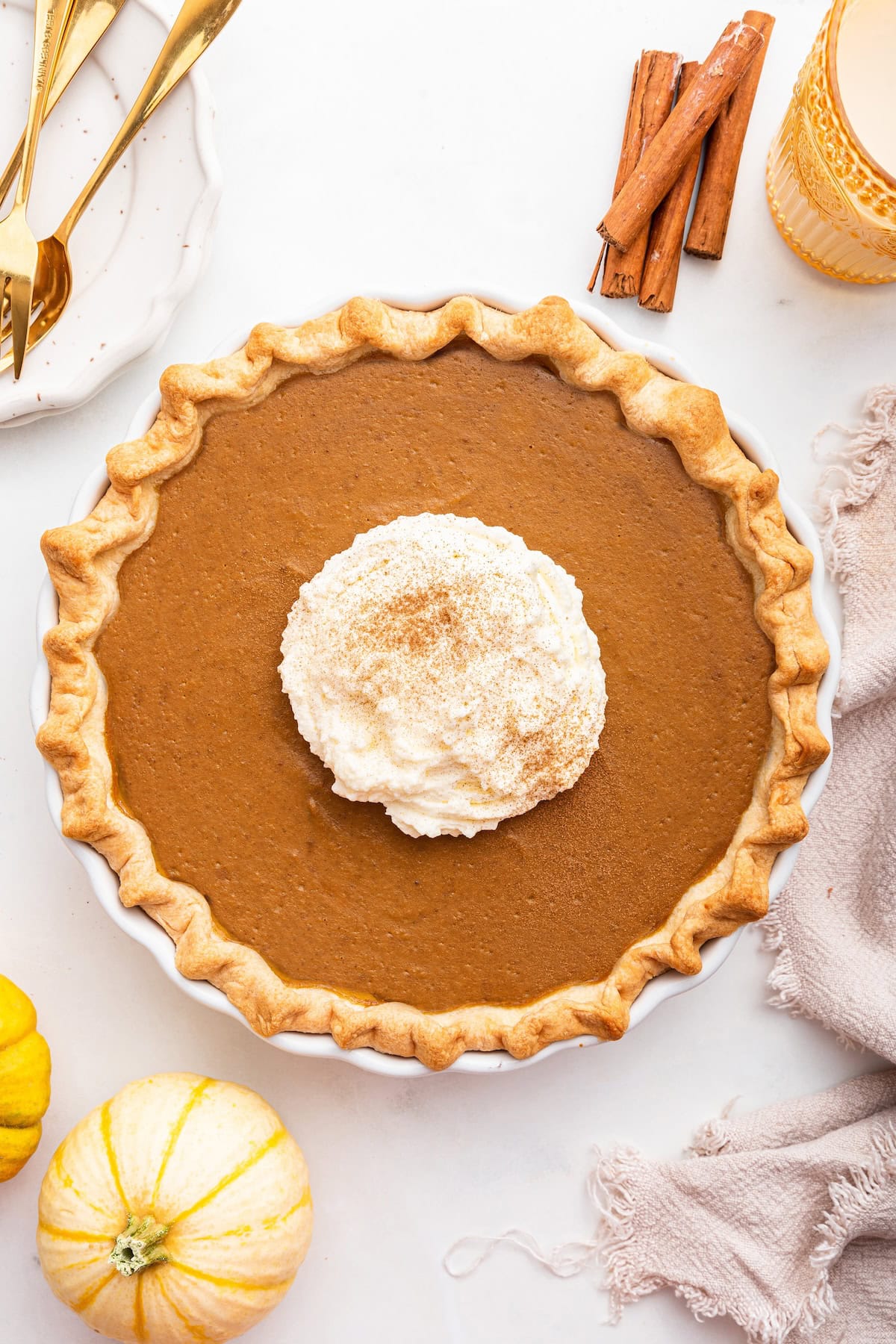 Healthy Pumpkin Pie topped with some whipped cream and cinnamon.