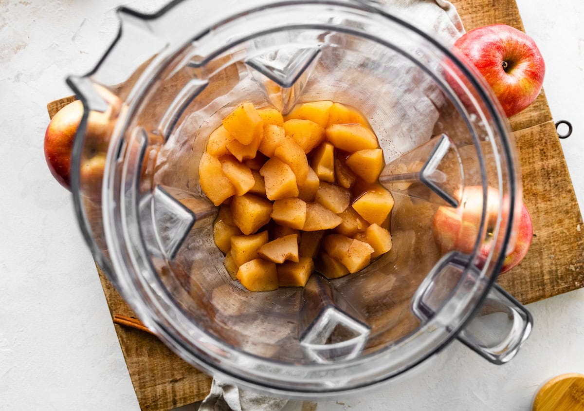 Cooked cinnamon apple chunks in a blender.