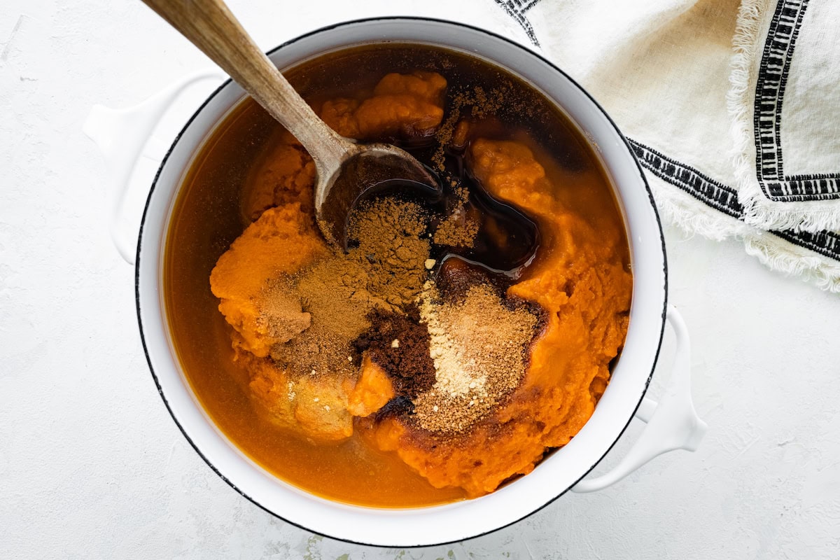 A pot full of pumpkin puree, warm spices, sweeteners, and water used to make pumpkin butter.