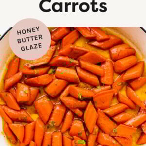 Glazed Carrots in a pan topped with chopped parsley.