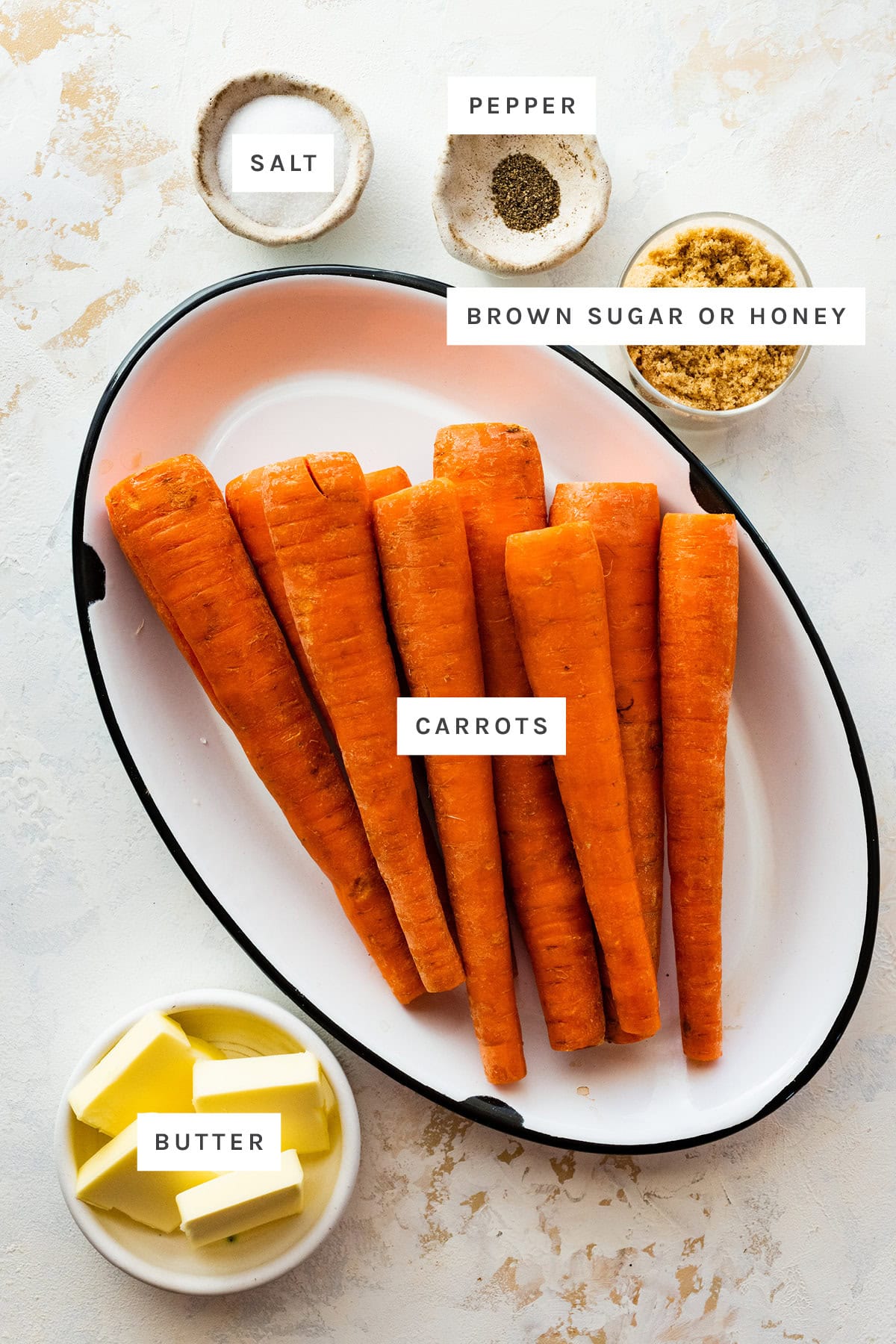 Ingredients measured out to make Glazed Carrots: salt, pepper, brown sugar, carrots and butter.