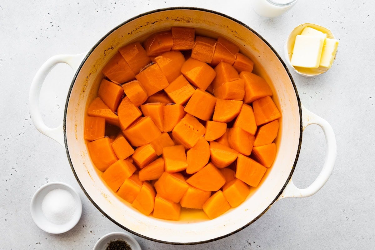 Cooked sweet potato chunks in a large pot.