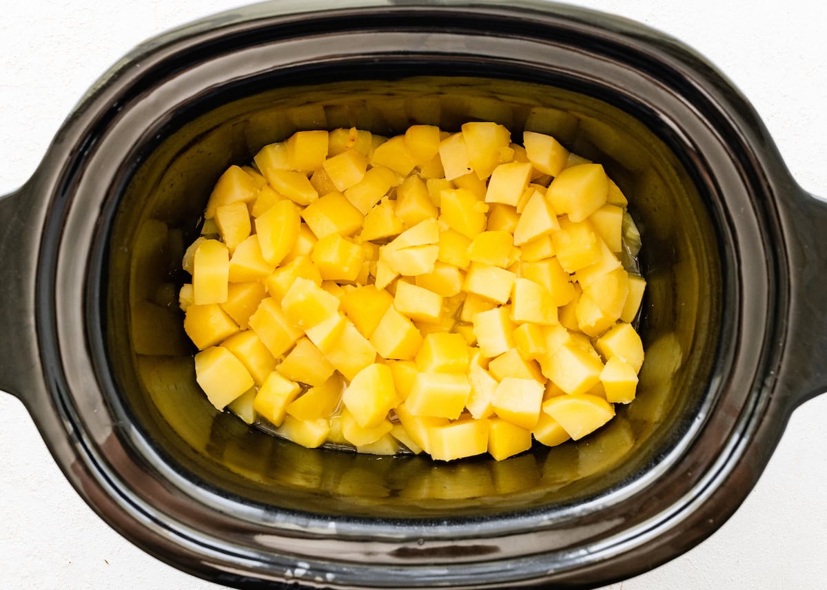 Chopped potatoes in a slow cooker.