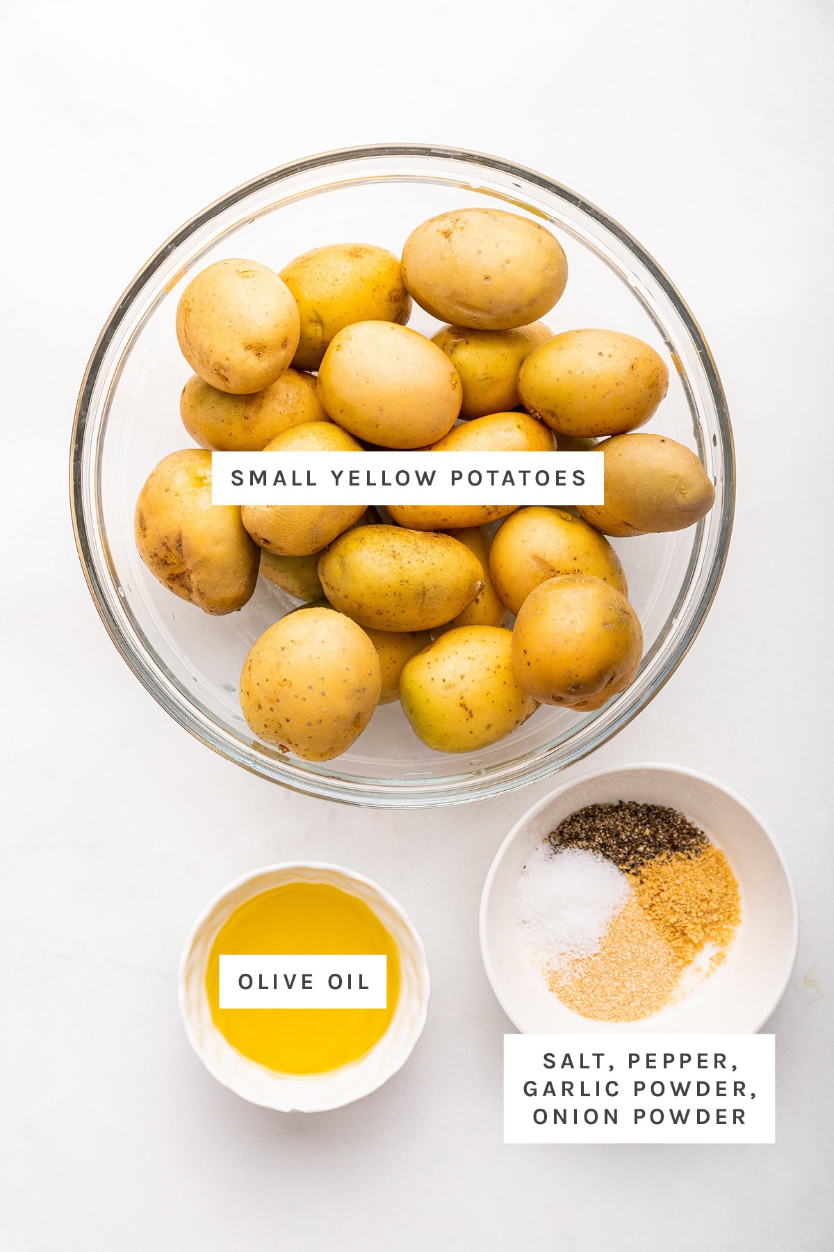 Ingredients measured out to make Smashed Potatoes: small yellow potatoes, olive oil, salt, pepper, garlic powder and onion powder.