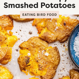 Smashed Potatoes on a sheet pan topped with flakey salt.