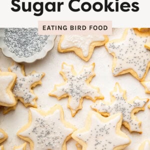 Snowflake and star sugar cookies with frosting and silver spinkles.
