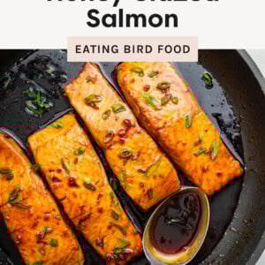 Four Honey Glazed Salmon filets in a skillet.