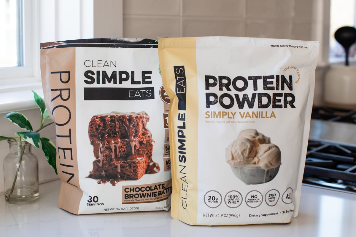 Two bags of Clean Simple Eats protein powder. One chocolate brownie batter and one simply vanilla