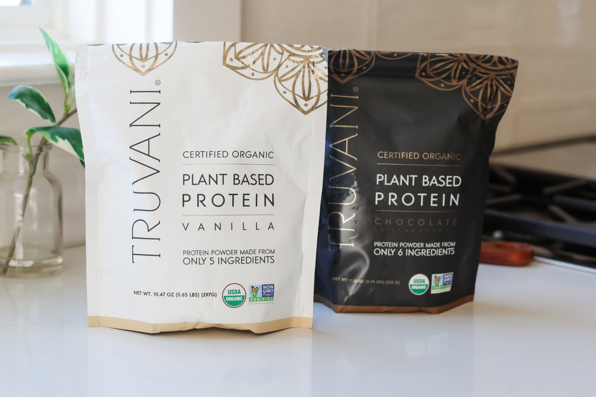 Two bags of Truvani protein powder, one chocolate and one vanilla.