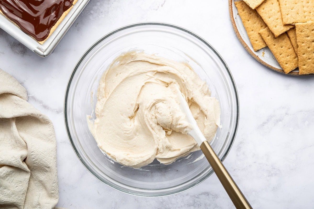Bowl of whipped protein and coco whip mixture with spatula.