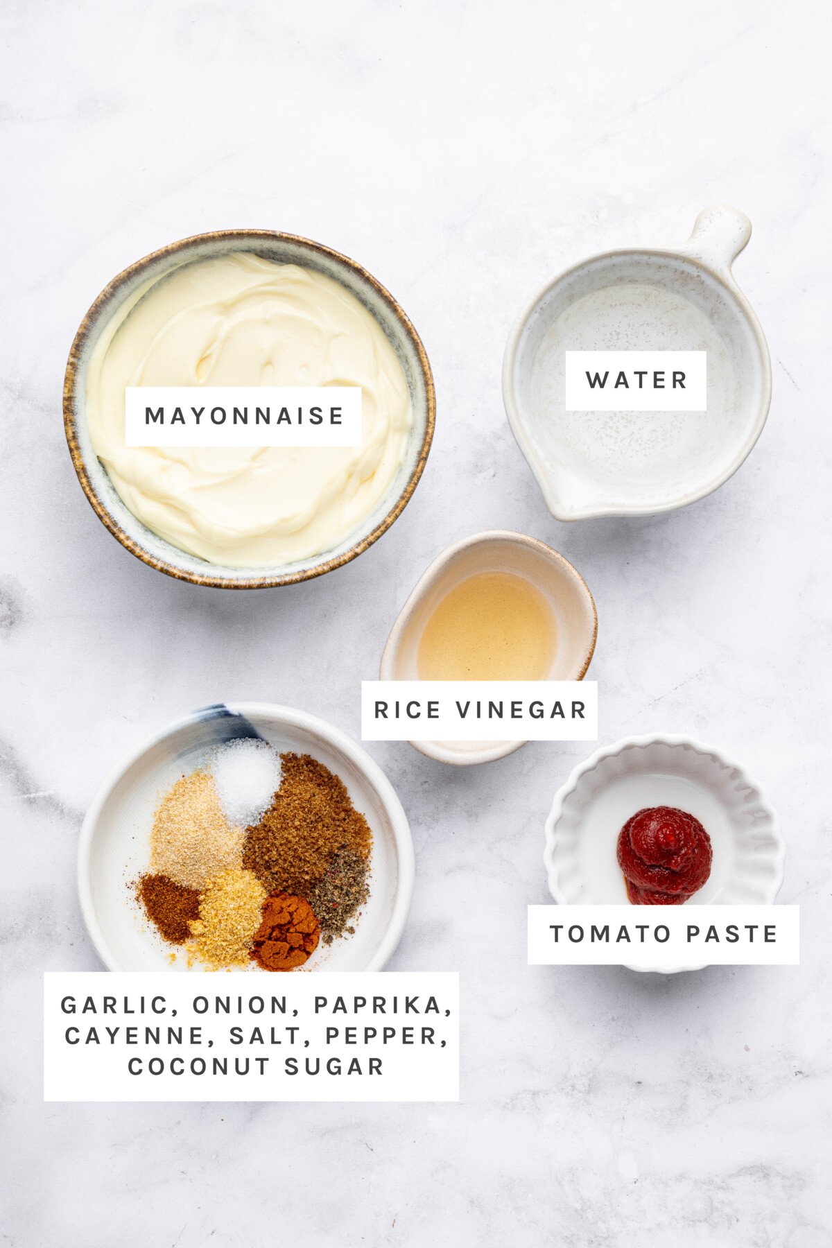 Ingredients measured out to make: Mayonnaise, Water, Rice Vinegar, Tomato Paste, Garlic, Onion, Paprika, Cayenne, Salt, Pepper, Coconut Sugar