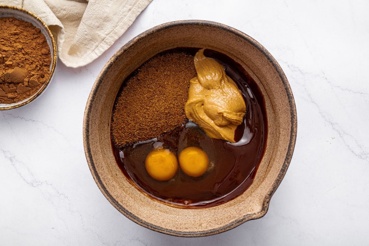 The wet ingredients for the peanut butter brownies in a mixing bowl.