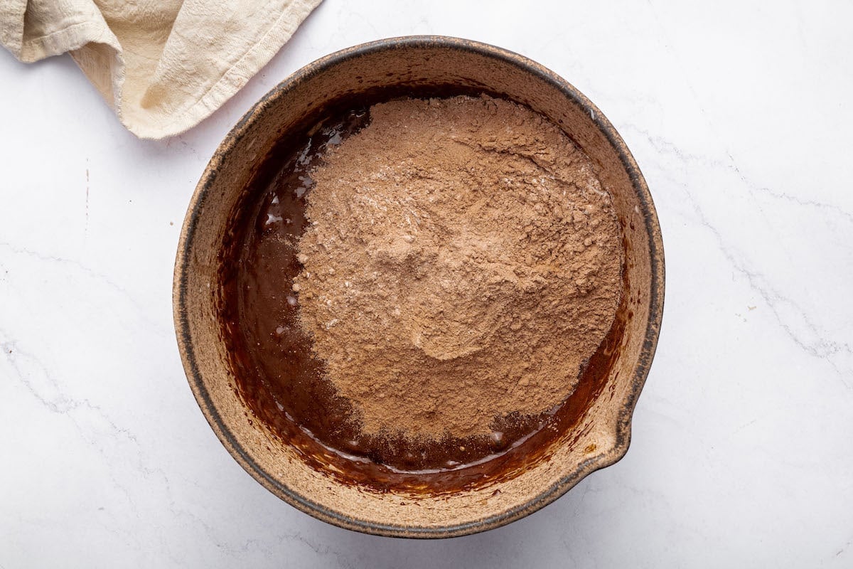 The dry and wet ingredients for the peanut butter brownies combined in a mixing bowl.