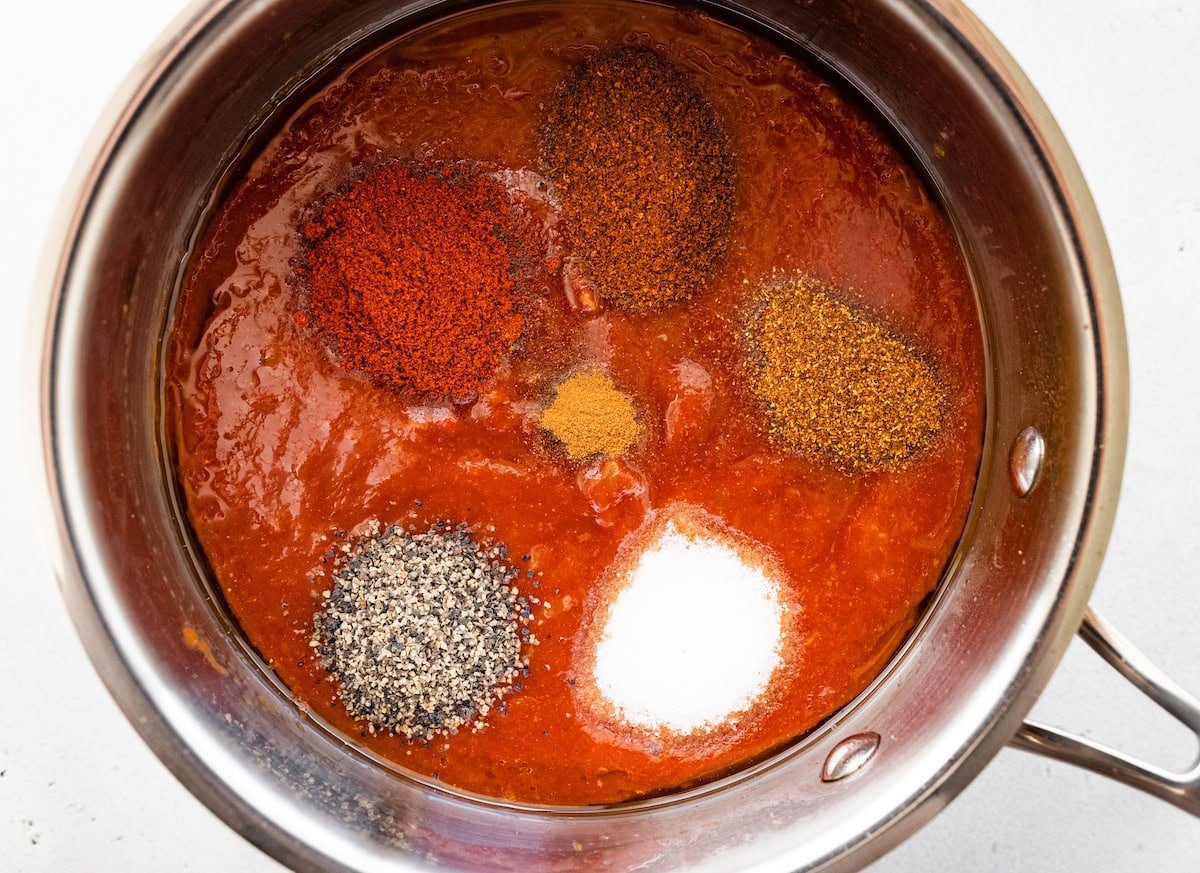 The spices added to the homemade BBQ sauce in the saucepan.