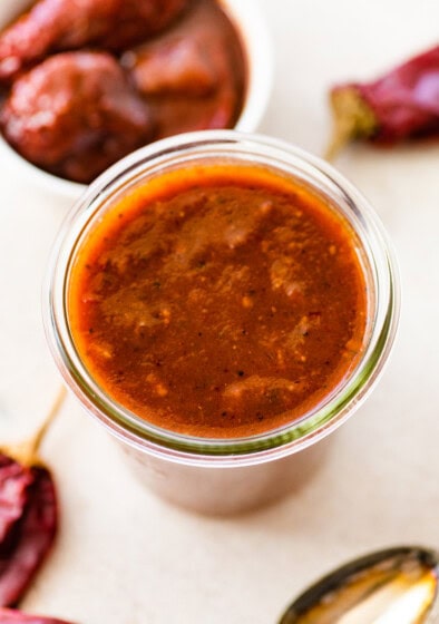 A glass weck jar filled with homemade red enchilada sauce.