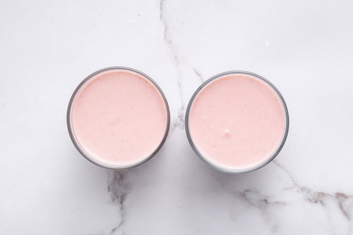 The strawberry cottage cheese mixture divided between two glasses.
