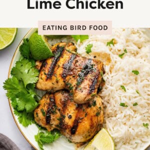Grilled cilantro lime chicken served with rice, garnished with lime and cilantro.