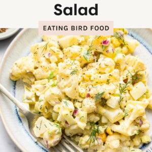 Plate of creamy low-carb cauliflower potato salad garnished with dill, with bold text overlay promoting it as a great option for BBQs and meal prep.