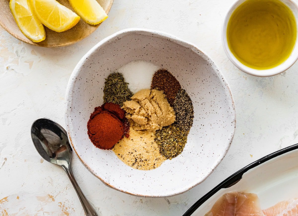 The blackened seasoning spice blend in a small bowl next to a spoon.