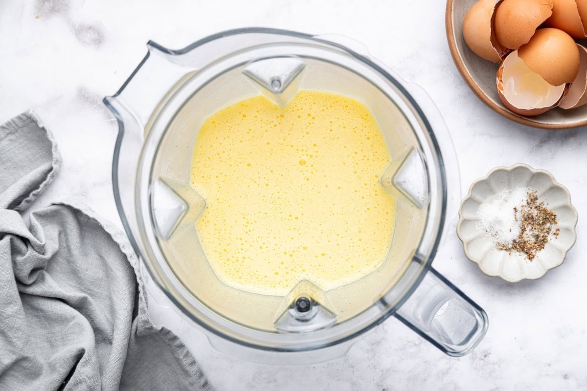 The cottage cheese egg bite mixture blended up in the base of a blender.
