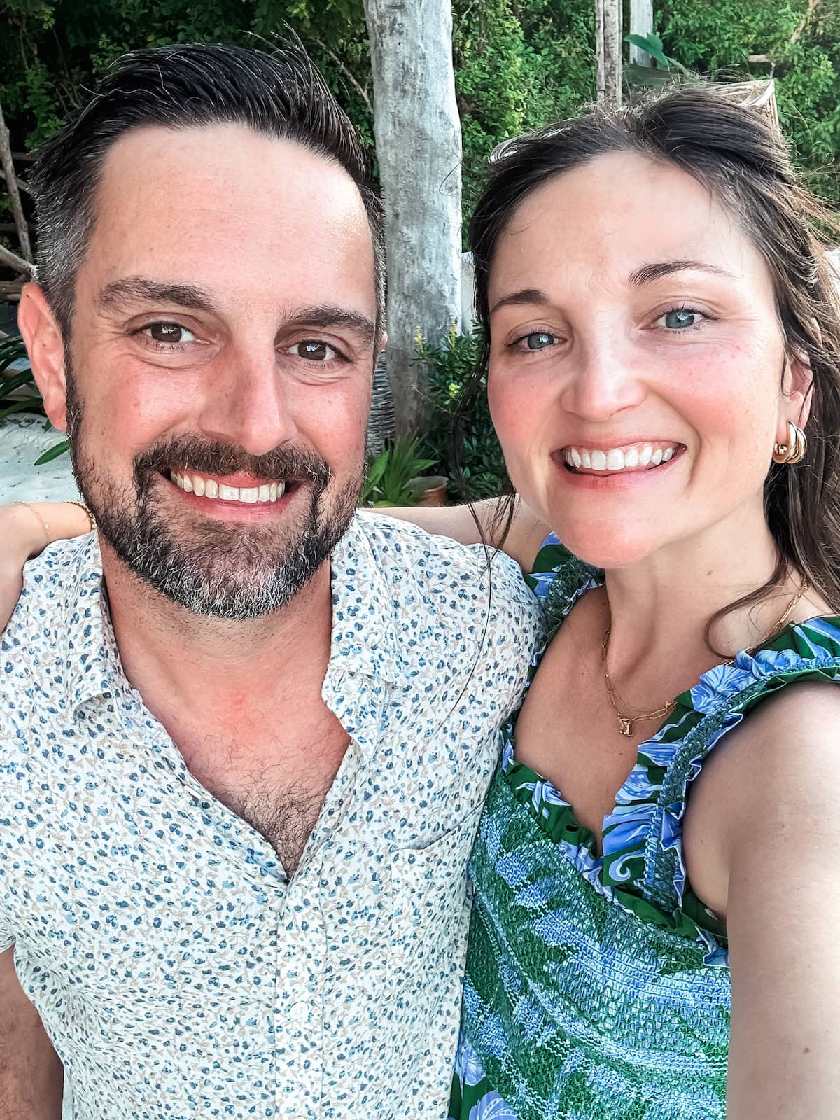 A man and a woman smile for a photo together.