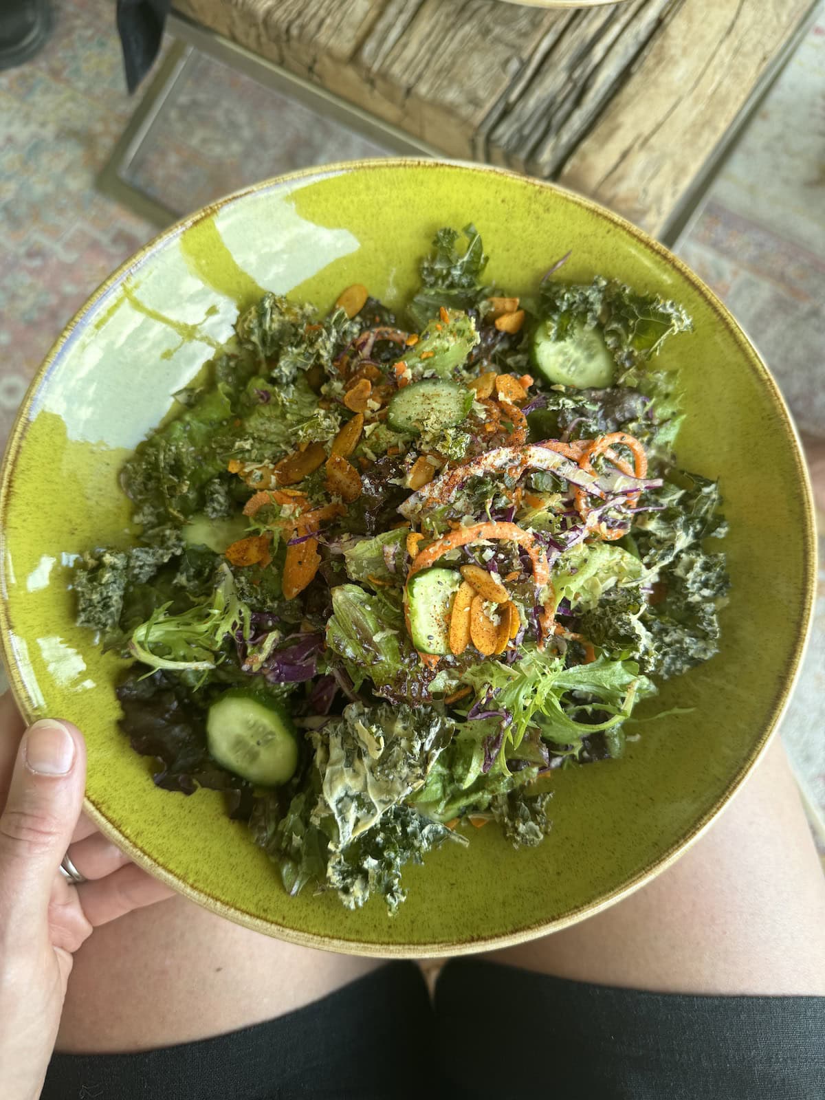 A green bowl of fresh salad.