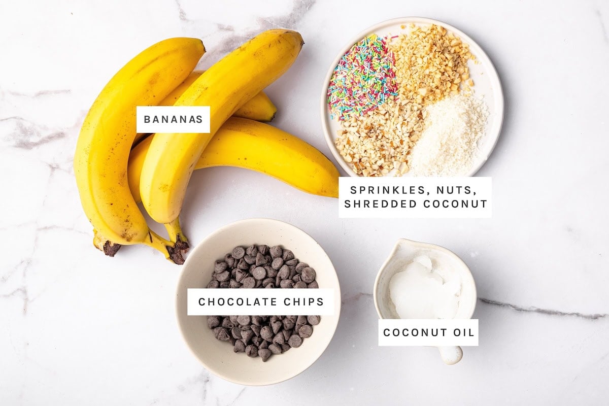 Frozen Chocolate Covered Bananas ingredients: Bananas, sprinkles, chopped nuts, shredded coconut, chocolate chips, coconut oil