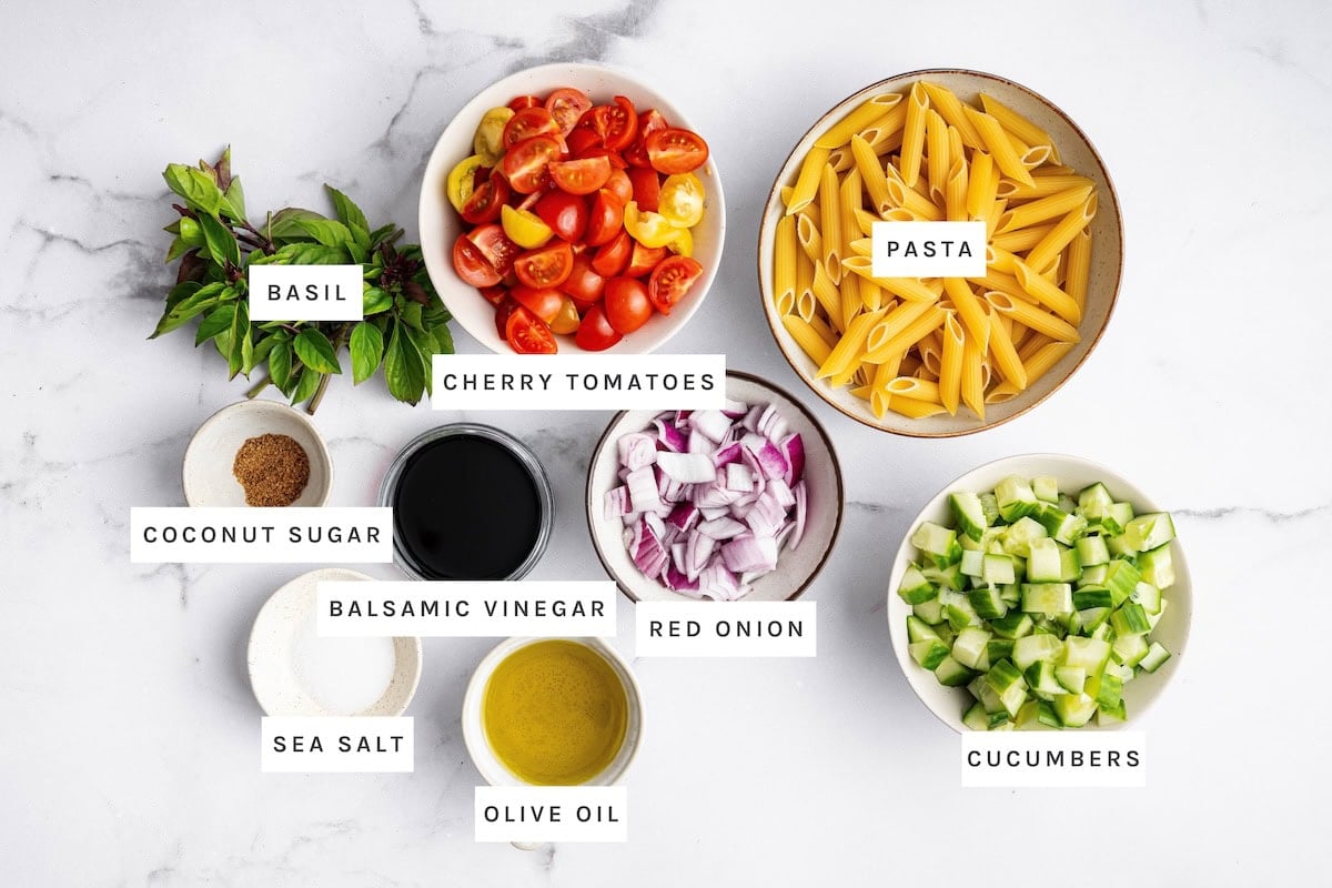 Healthy Pasta Salad ingredients: Basil, Cherry Tomatoes, Pasta, Coconut Sugar, Balsamic Vinegar, Red Onion, Cucumbers, Sea Salt, Olive Oil