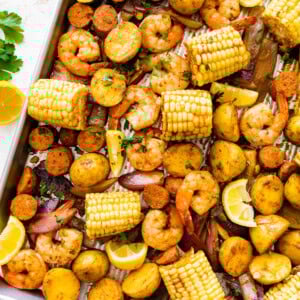 Sheet pan shrimp boil with golden potatoes, shrimp, sausage, and corn.