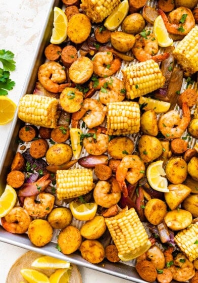 Sheet pan shrimp boil with golden potatoes, shrimp, sausage, and corn.