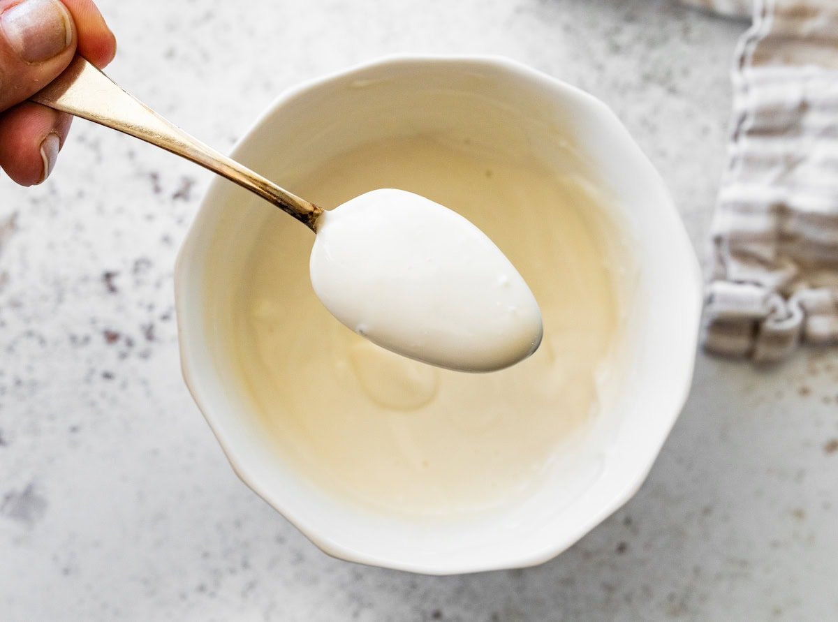 Spoon showing the creamy mascarpone-style yogurt topping.