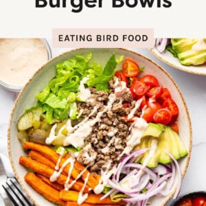 Overhead shot of a loaded burger bowl with sauce drizzle.