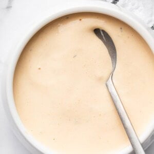Homemade Big Mac sauce in a white bowl with a silver spoon.