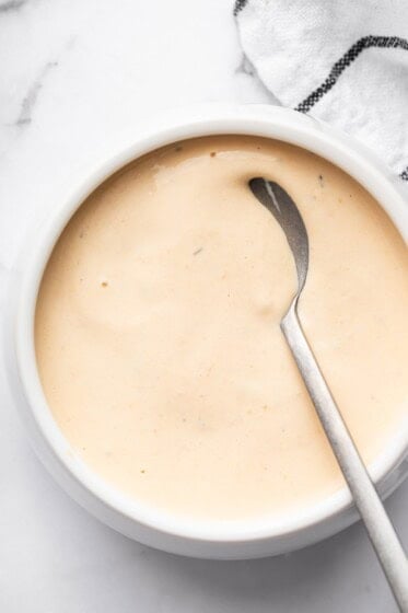 Homemade Big Mac sauce in a white bowl with a silver spoon.