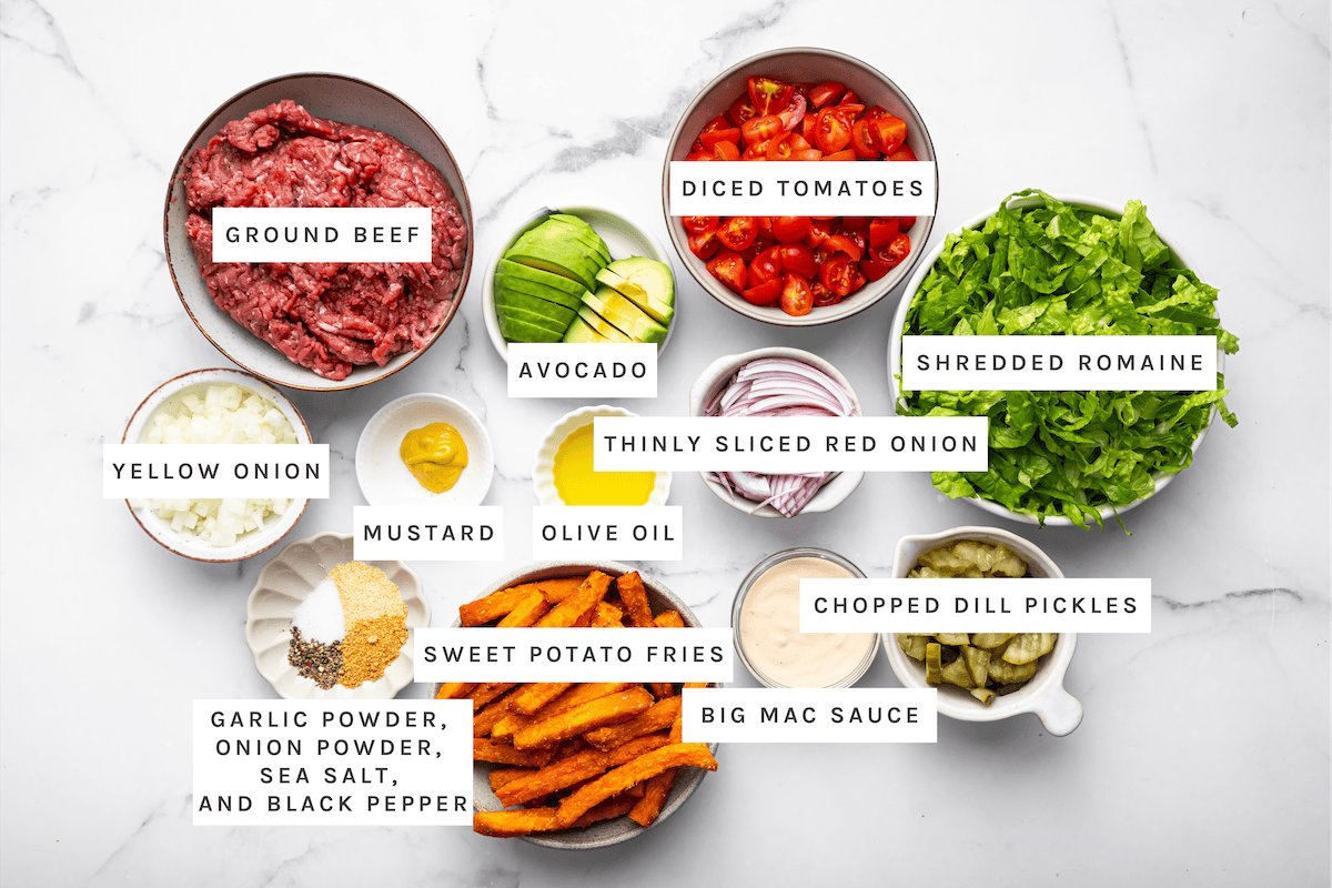 Burger Bowls ingredients: Ground beef, diced tomatoes, shredded romaine, avocado, thinly sliced red onion, chopped dill pickles, yellow onion, mustard, olive oil, sweet potato fries, Big Mac sauce, garlic powder, onion powder, sea salt, black pepper