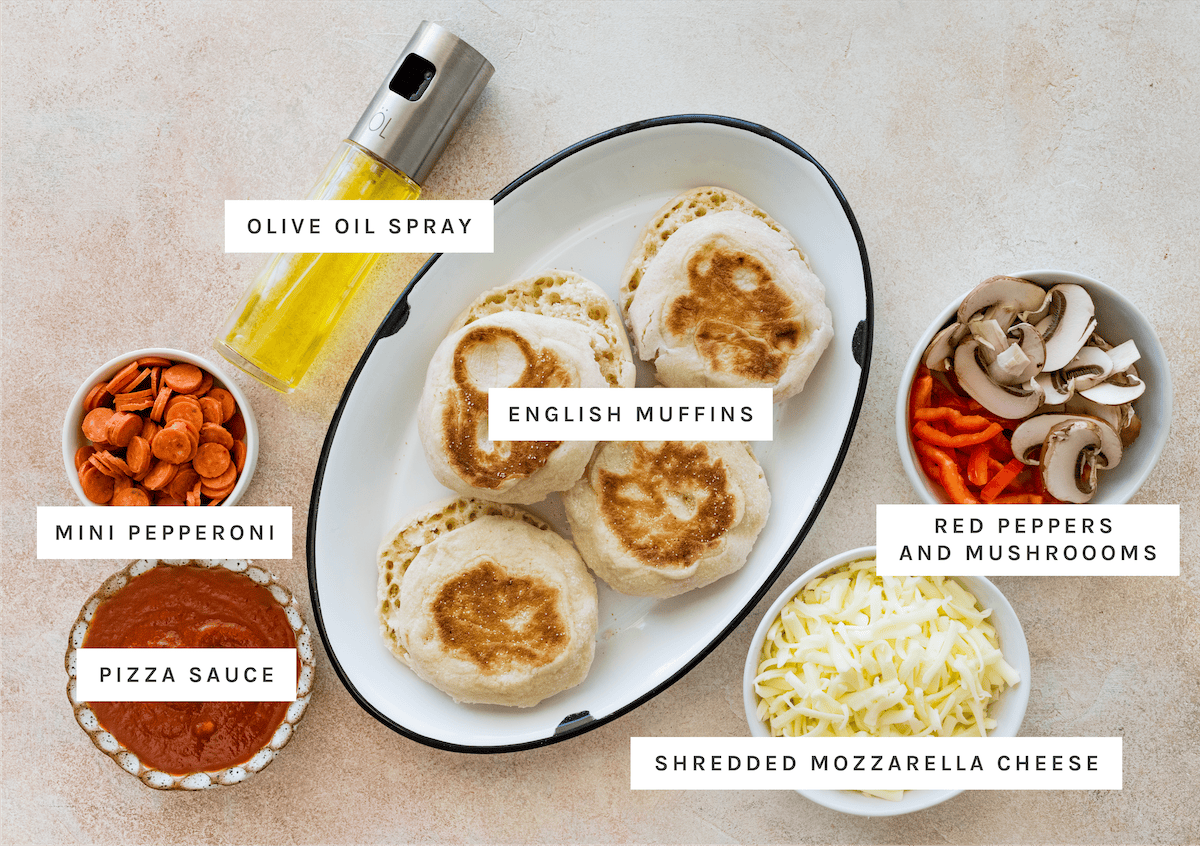 English Muffin Pizza ingredients: Olive oil spray, English muffins, Mini pepperoni, Pizza sauce, Red peppers, Mushrooms, Shredded mozzarella cheese