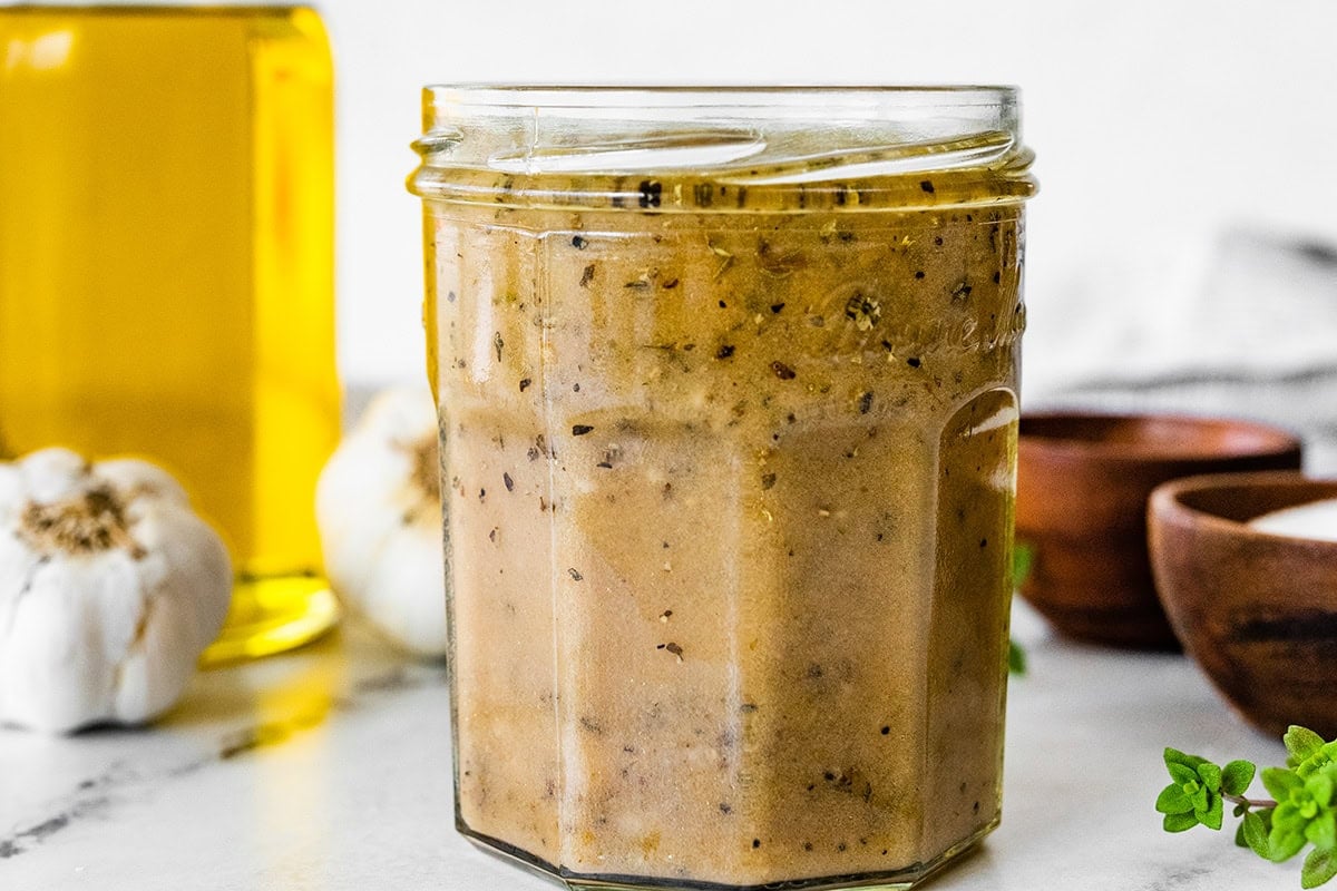 Glass jar filled with creamy homemade Italian dressing.