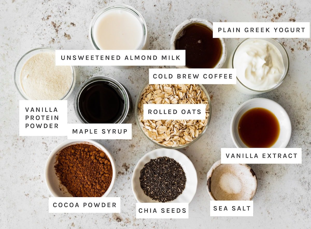Tiramisu Overnight Oats ingredients: Unsweetened almond milk, plain Greek yogurt, cold brew coffee, rolled oats, vanilla protein powder, maple syrup, vanilla extract, cocoa powder, chia seeds, sea salt.