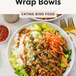 Bowl of chicken lettuce wrap with cauliflower rice, carrots, ground chicken, and sauce.