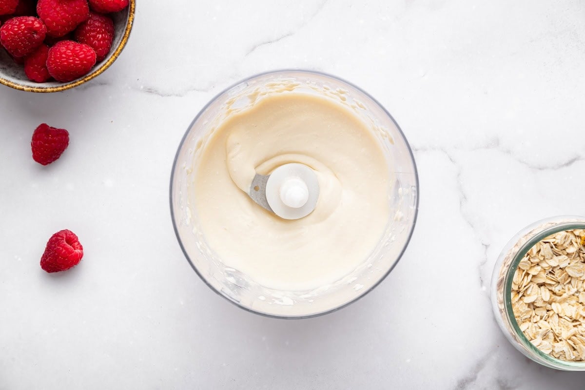 Smooth blended cottage cheese swirl mixture in food processor bowl.
