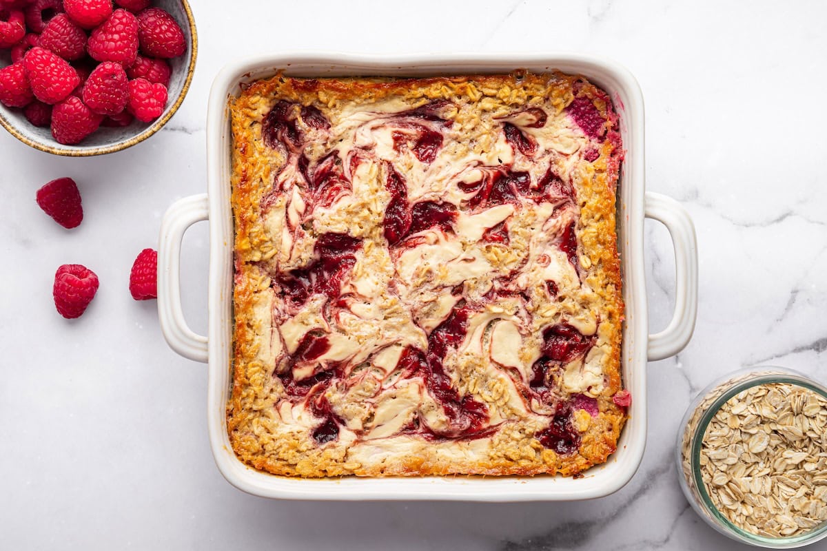 Cottage cheese baked oatmeal in a white baking dish with golden edges and after baking.