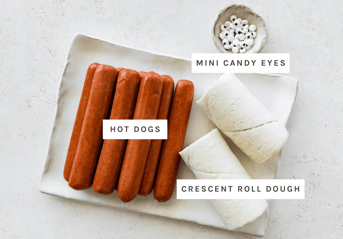Hot dogs, crescent roll dough, mini candy eyes