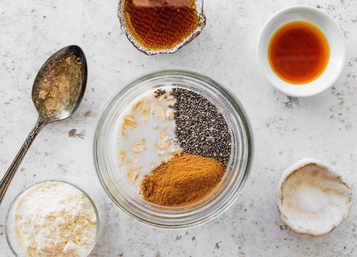 Ingredients for snickerdoodle overnight oats Ingredients for snickerdoodle overnight oats in a jar, including oats, chia seeds, cinnamon and milk.