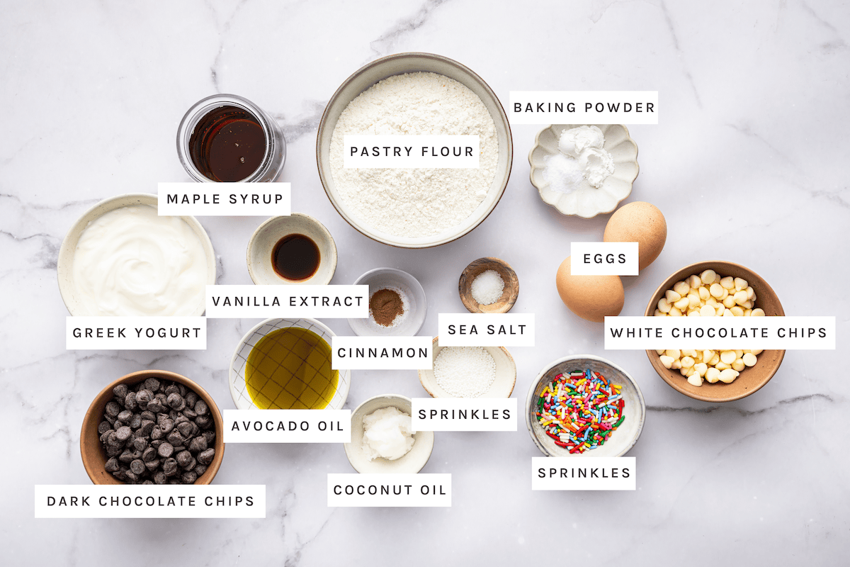 Maple Syrup, Pastry Flour, Baking Powder, Eggs, White Chocolate Chips, Sprinkles, Sea Salt, Cinnamon, Vanilla Extract, Greek Yogurt, Avocado Oil, Coconut Oil, Dark Chocolate Chips