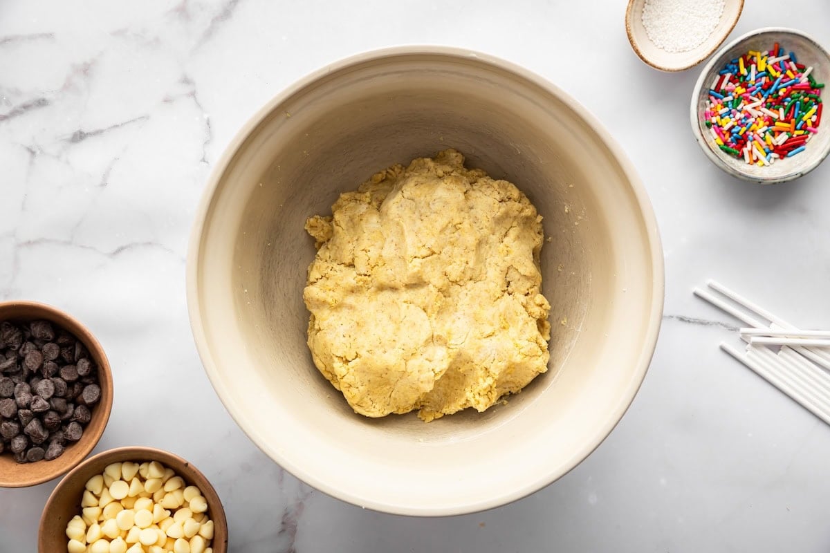 Bowl of cake mixture made with crumbled cake and Greek yogurt before rolling.