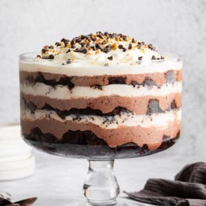 Assembled chocolate trifle showing layers of brownies, pudding, and whipped topping in a glass trifle dish.