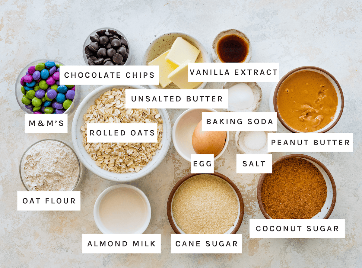 M&M's, Chocolate Chips, Unsalted Butter, Vanilla Extract, Oat Flour, Rolled Oats, Baking Soda, Peanut Butter, Almond Milk, Egg, Salt, Cane Sugar, and Coconut Sugar.