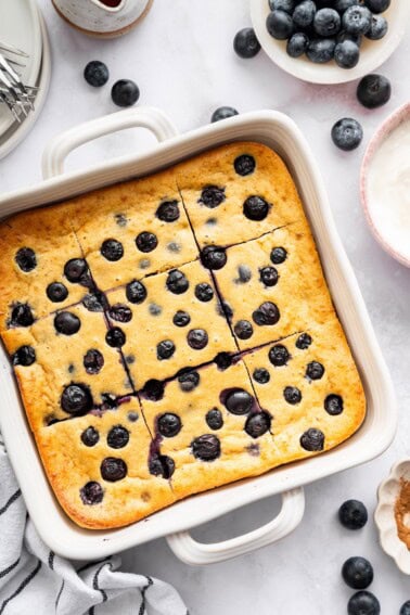 Blueberry cottage cheese breakfast bake cut into squares in a white baking dish.